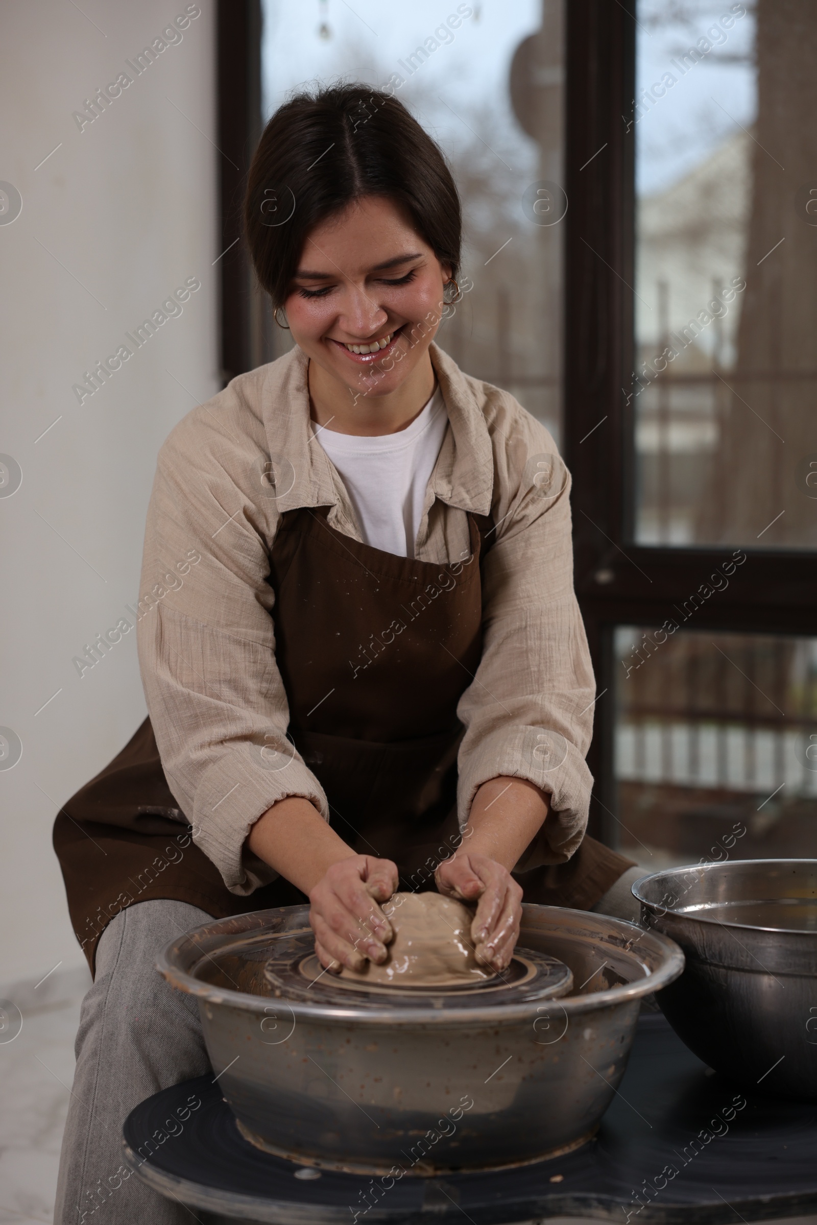 Photo of Hobby and craft. Smiling woman making pottery indoors