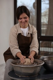 Photo of Hobby and craft. Smiling woman making pottery indoors