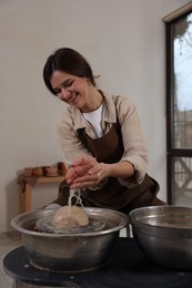 Photo of Hobby and craft. Smiling woman making pottery indoors