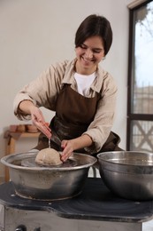 Photo of Hobby and craft. Smiling woman making pottery indoors