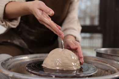 Photo of Hobby and craft. Woman making pottery indoors, closeup