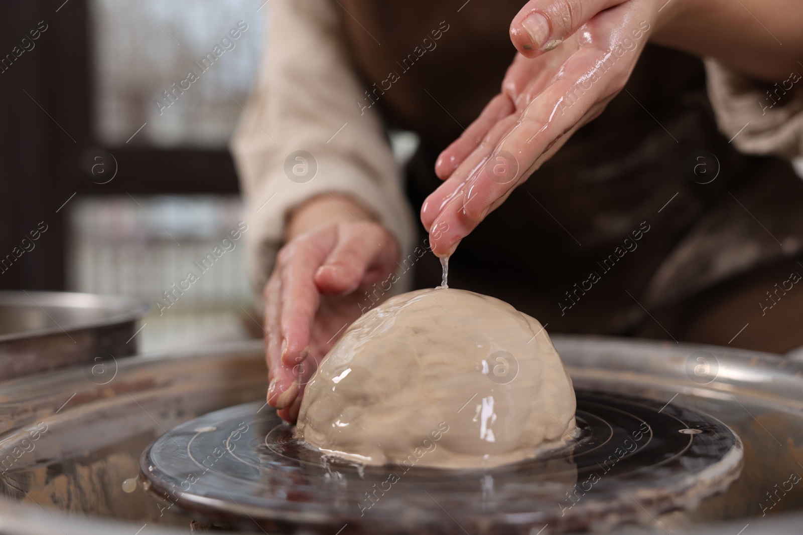 Photo of Hobby and craft. Woman making pottery indoors, closeup