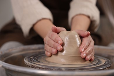 Photo of Hobby and craft. Woman making pottery indoors, closeup