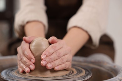 Photo of Hobby and craft. Woman making pottery indoors, closeup