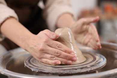 Photo of Hobby and craft. Woman making pottery indoors, closeup