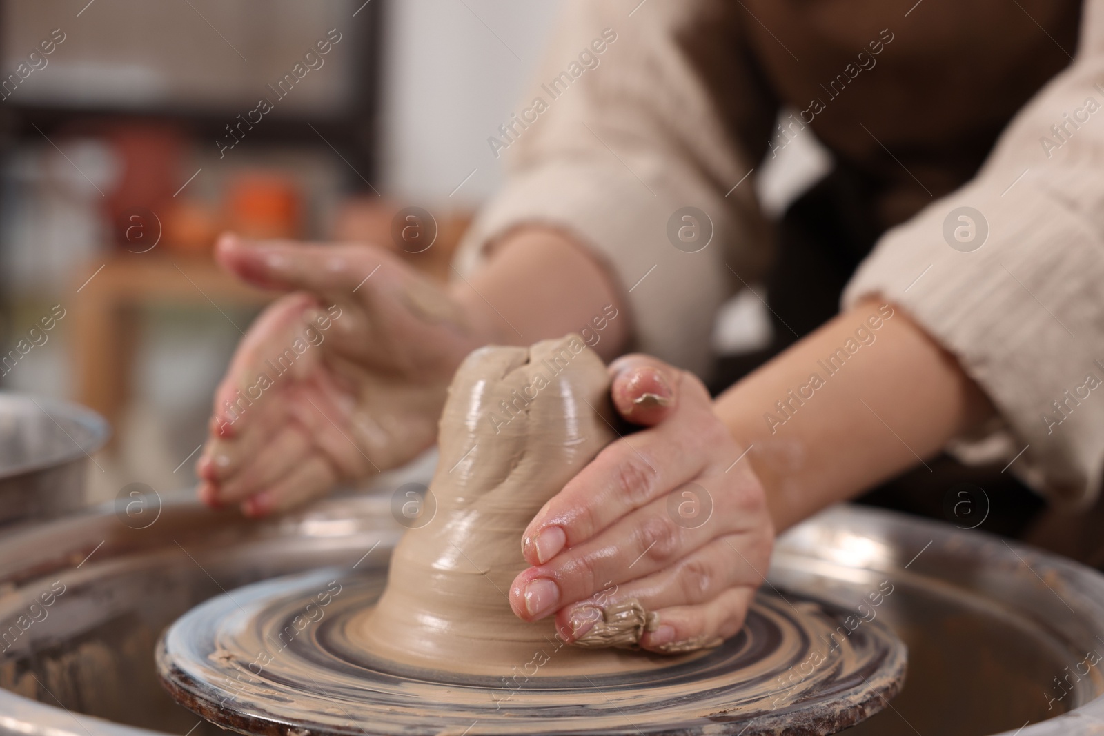 Photo of Hobby and craft. Woman making pottery indoors, closeup