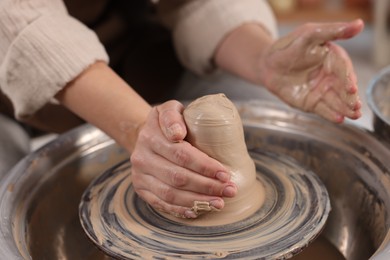 Photo of Hobby and craft. Woman making pottery indoors, closeup