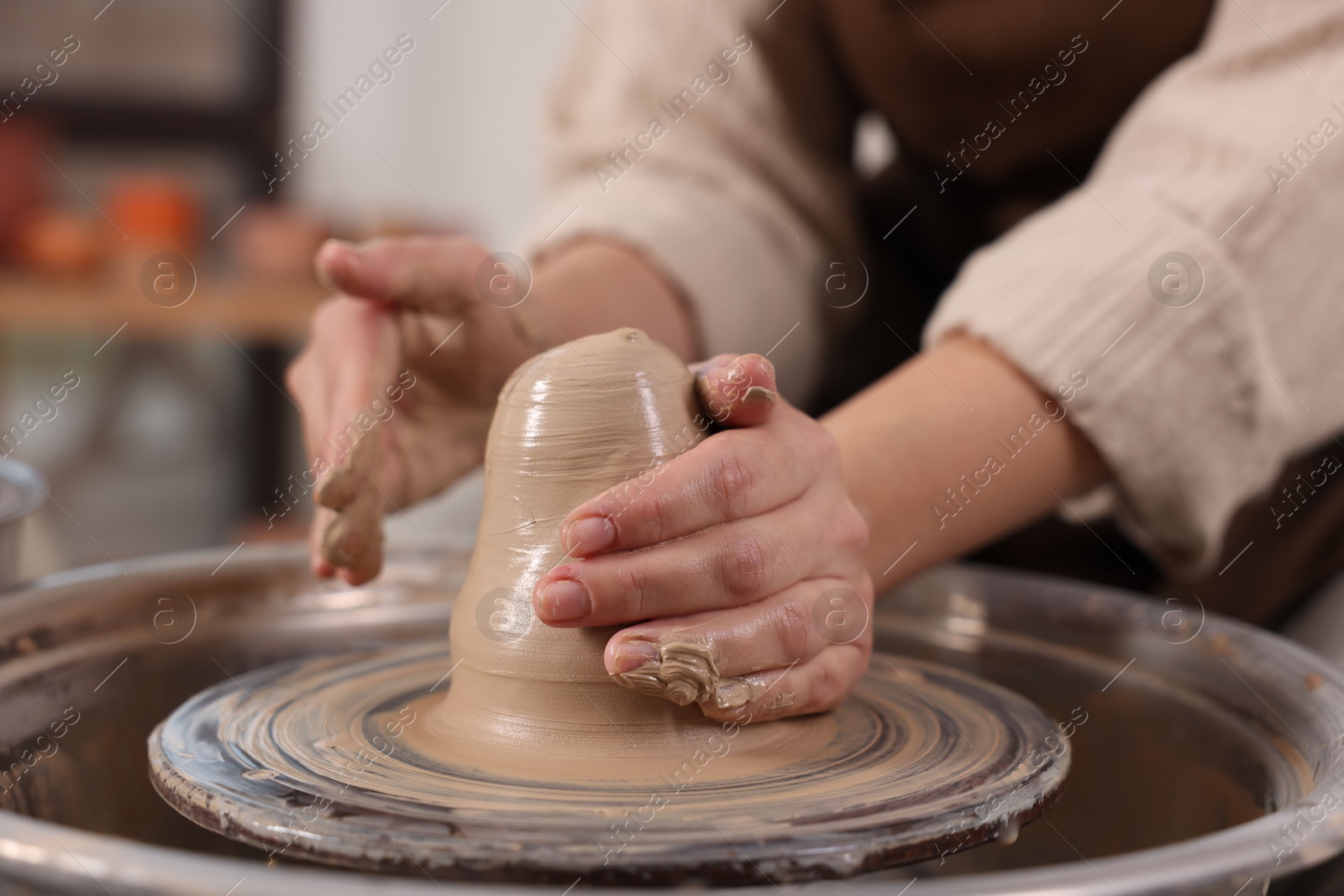 Photo of Hobby and craft. Woman making pottery indoors, closeup