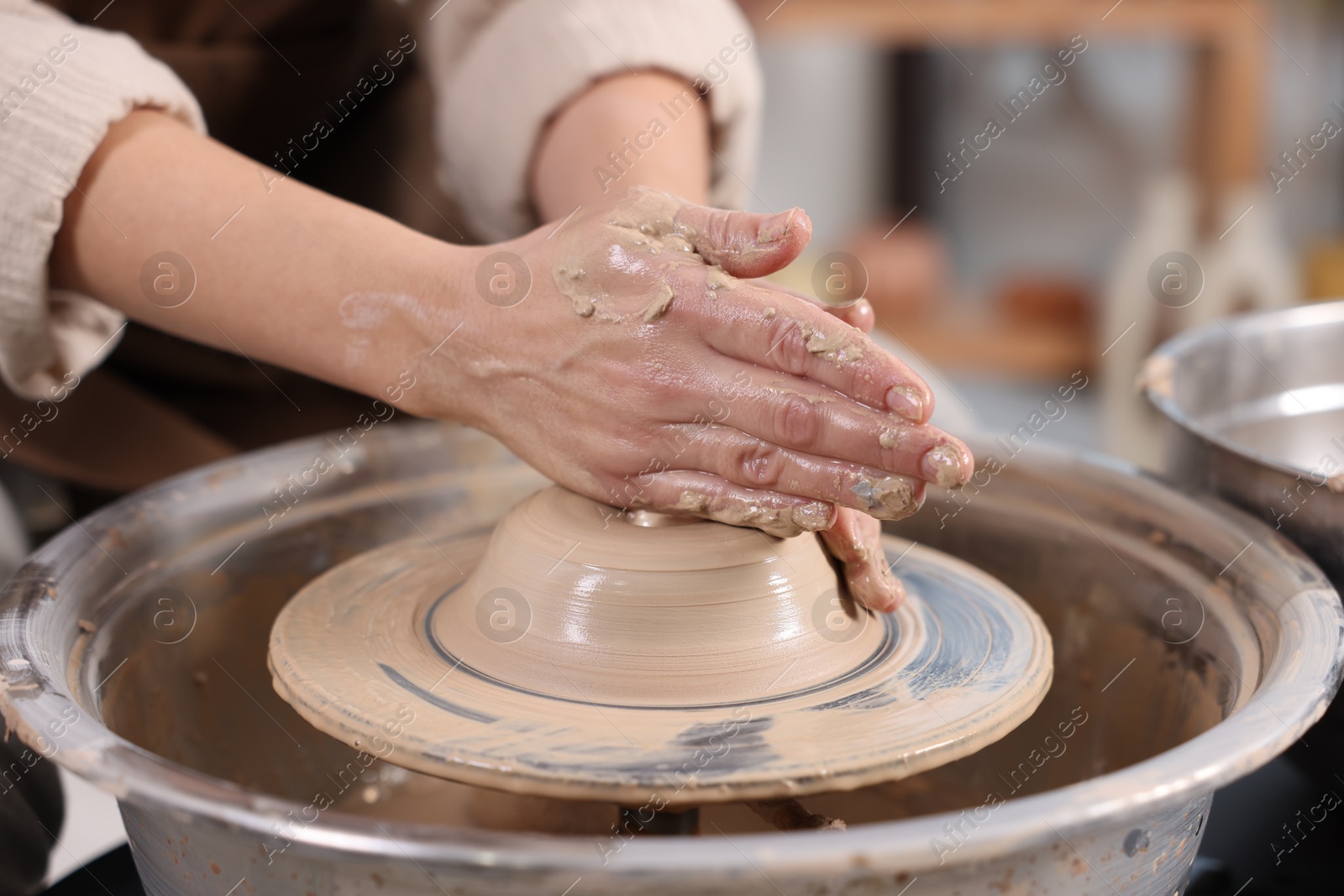 Photo of Hobby and craft. Woman making pottery indoors, closeup