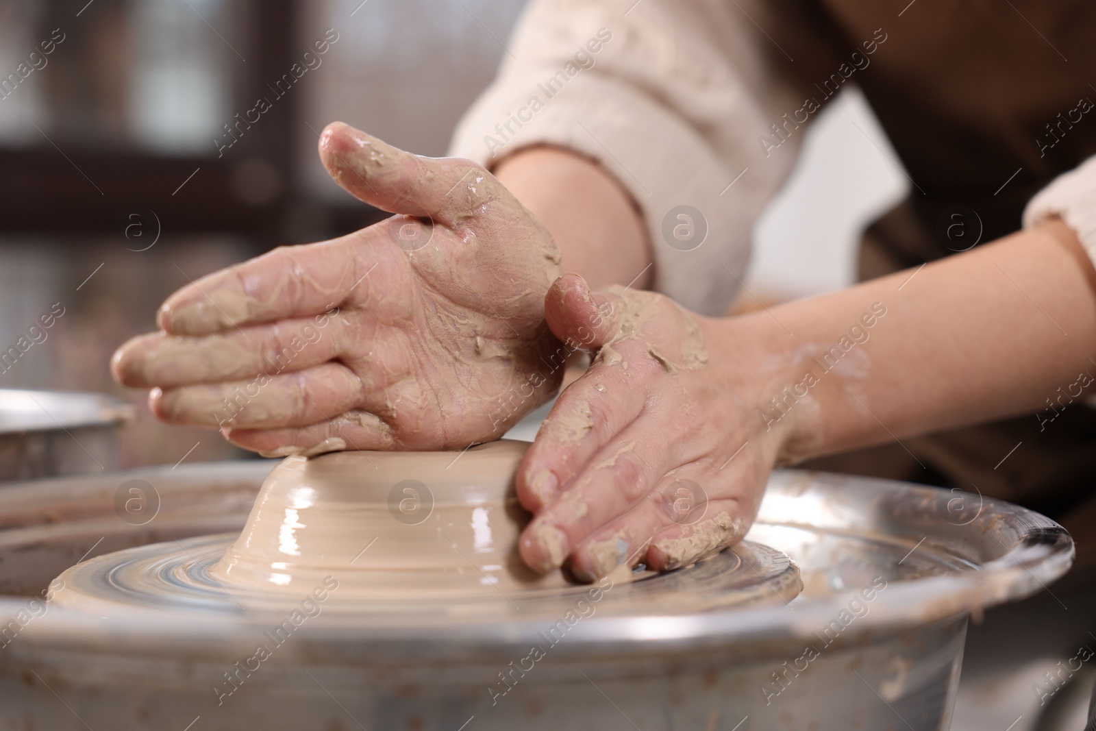 Photo of Hobby and craft. Woman making pottery indoors, closeup