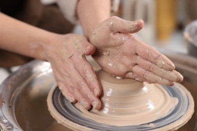 Photo of Hobby and craft. Woman making pottery indoors, closeup