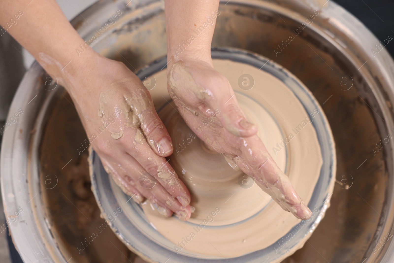 Photo of Hobby and craft. Woman making pottery indoors, closeup