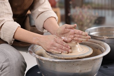 Photo of Hobby and craft. Woman making pottery indoors, closeup