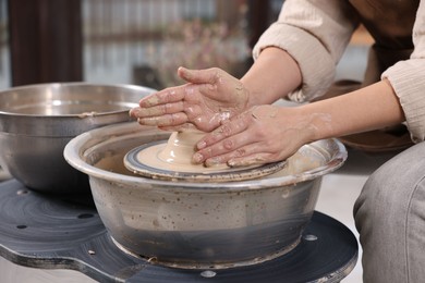 Photo of Hobby and craft. Woman making pottery indoors, closeup