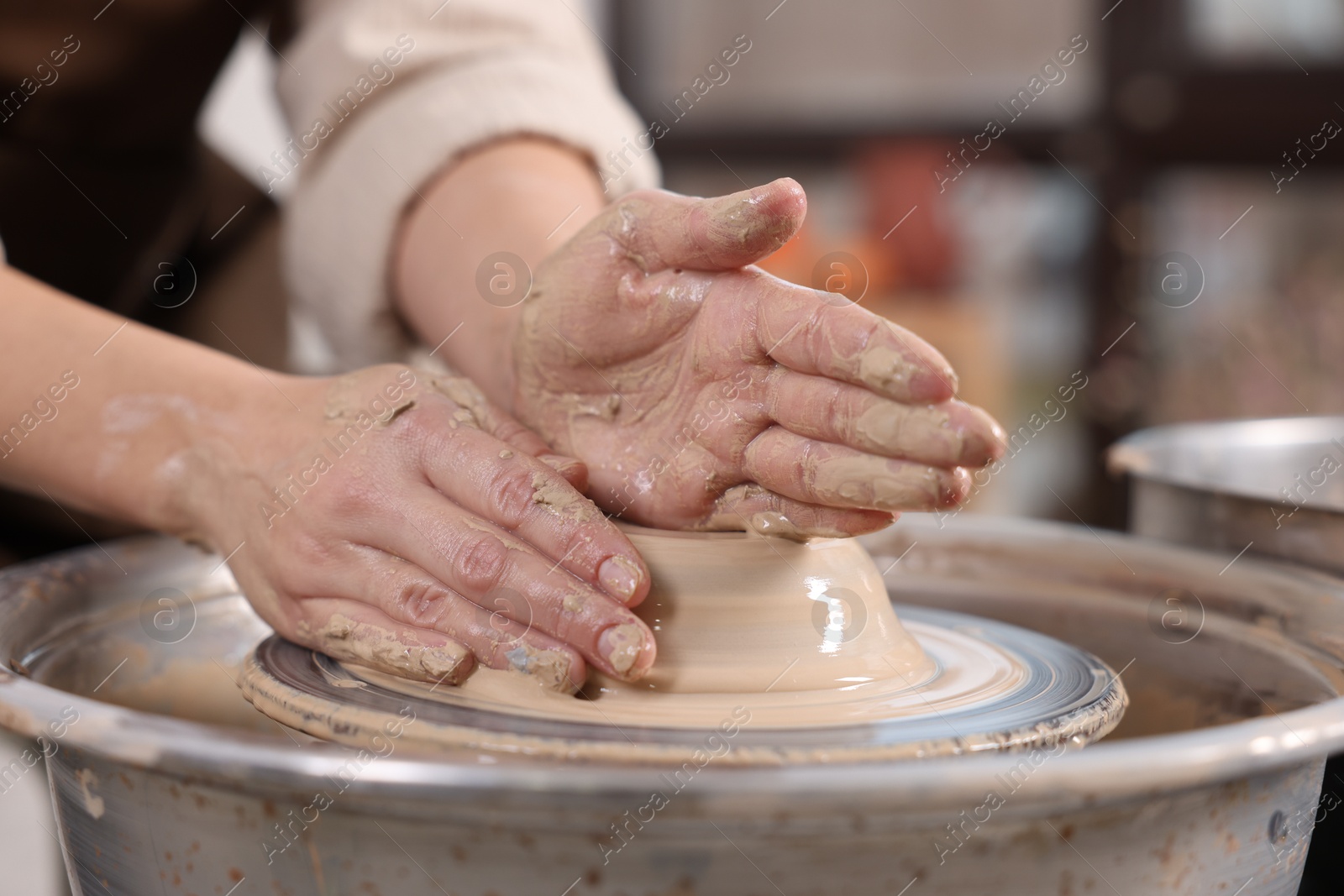 Photo of Hobby and craft. Woman making pottery indoors, closeup