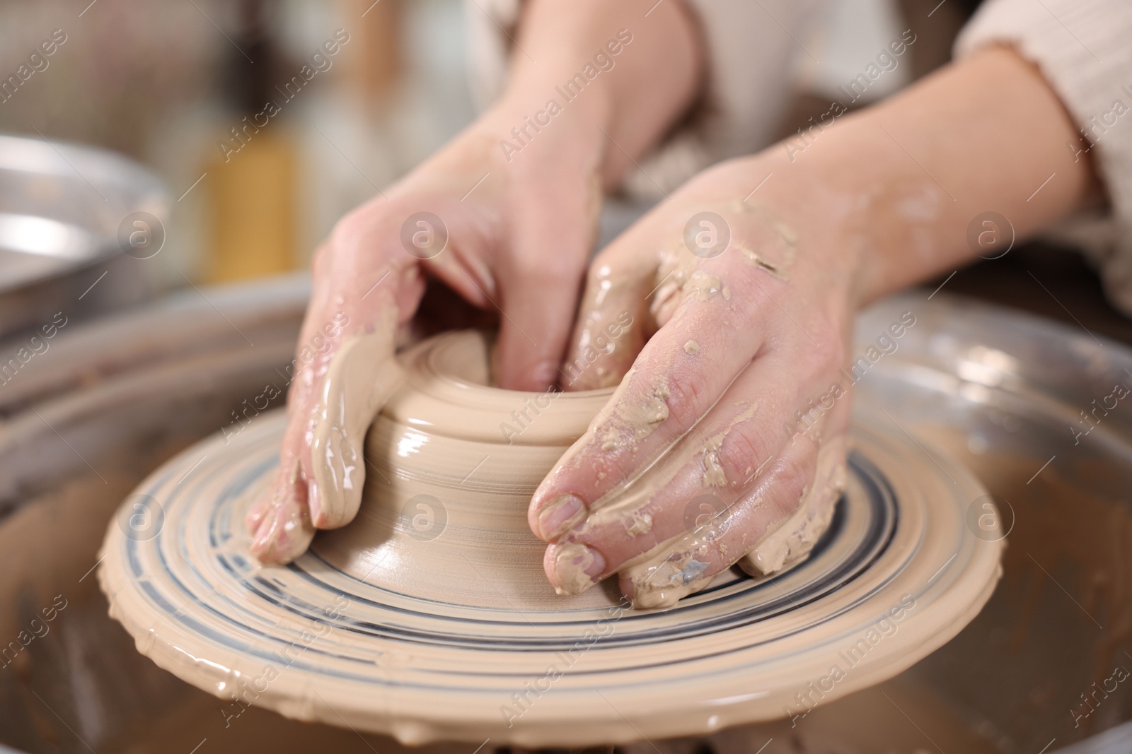 Photo of Hobby and craft. Woman making pottery indoors, closeup