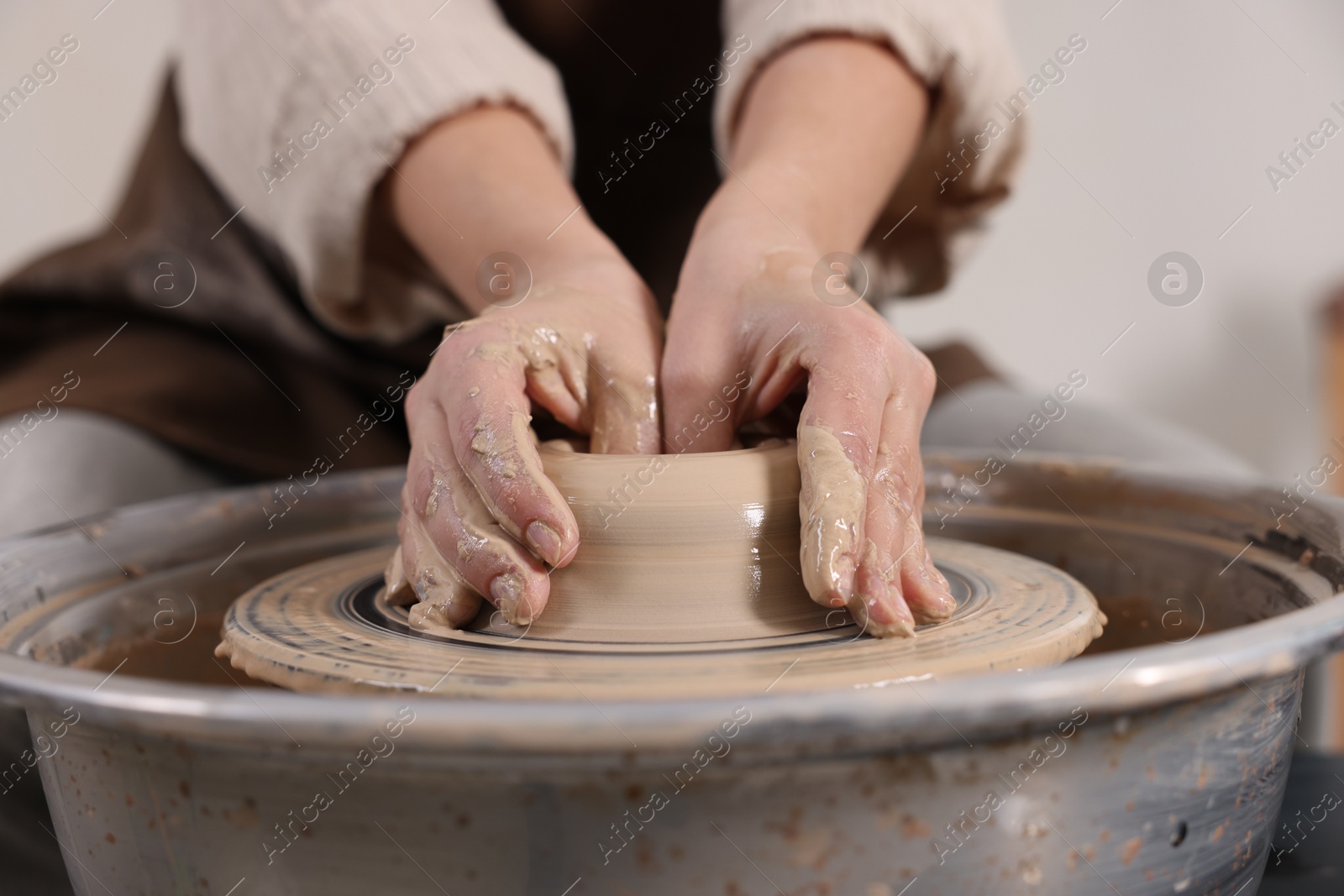 Photo of Hobby and craft. Woman making pottery indoors, closeup