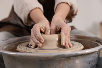 Photo of Hobby and craft. Woman making pottery indoors, closeup