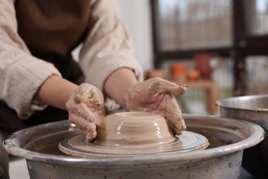 Photo of Hobby and craft. Woman making pottery indoors, closeup