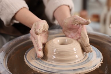 Photo of Hobby and craft. Woman making pottery indoors, closeup