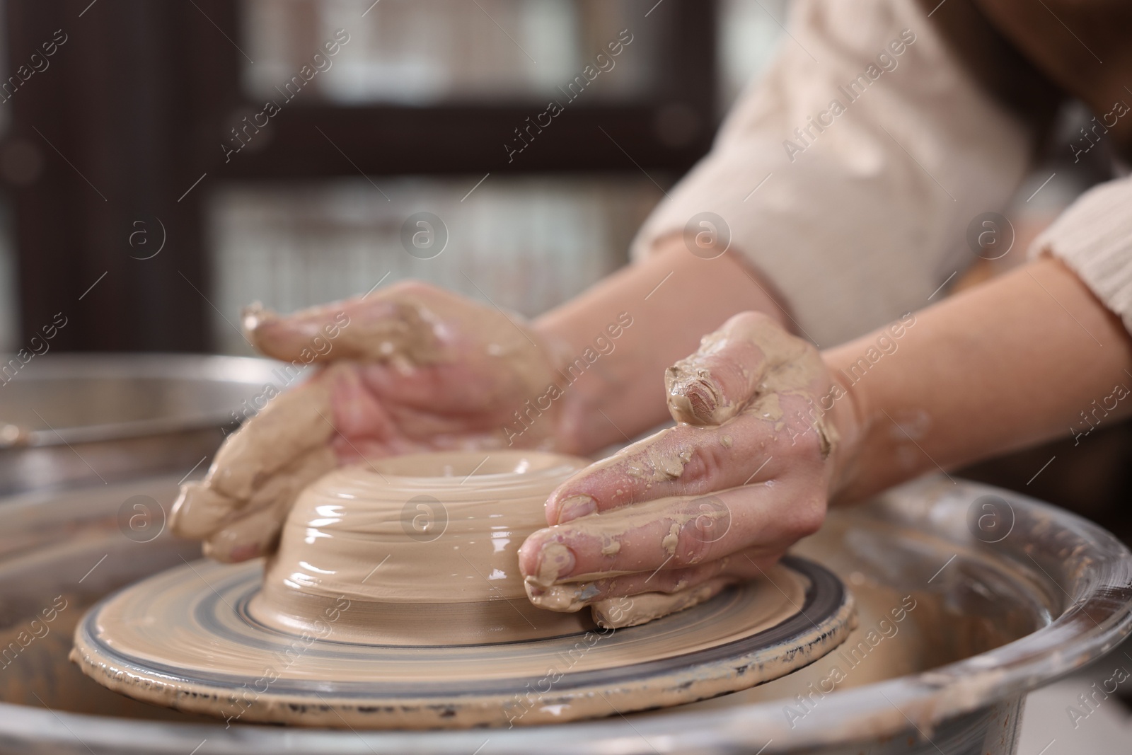 Photo of Hobby and craft. Woman making pottery indoors, closeup