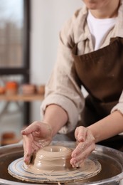 Photo of Hobby and craft. Woman making pottery indoors, closeup