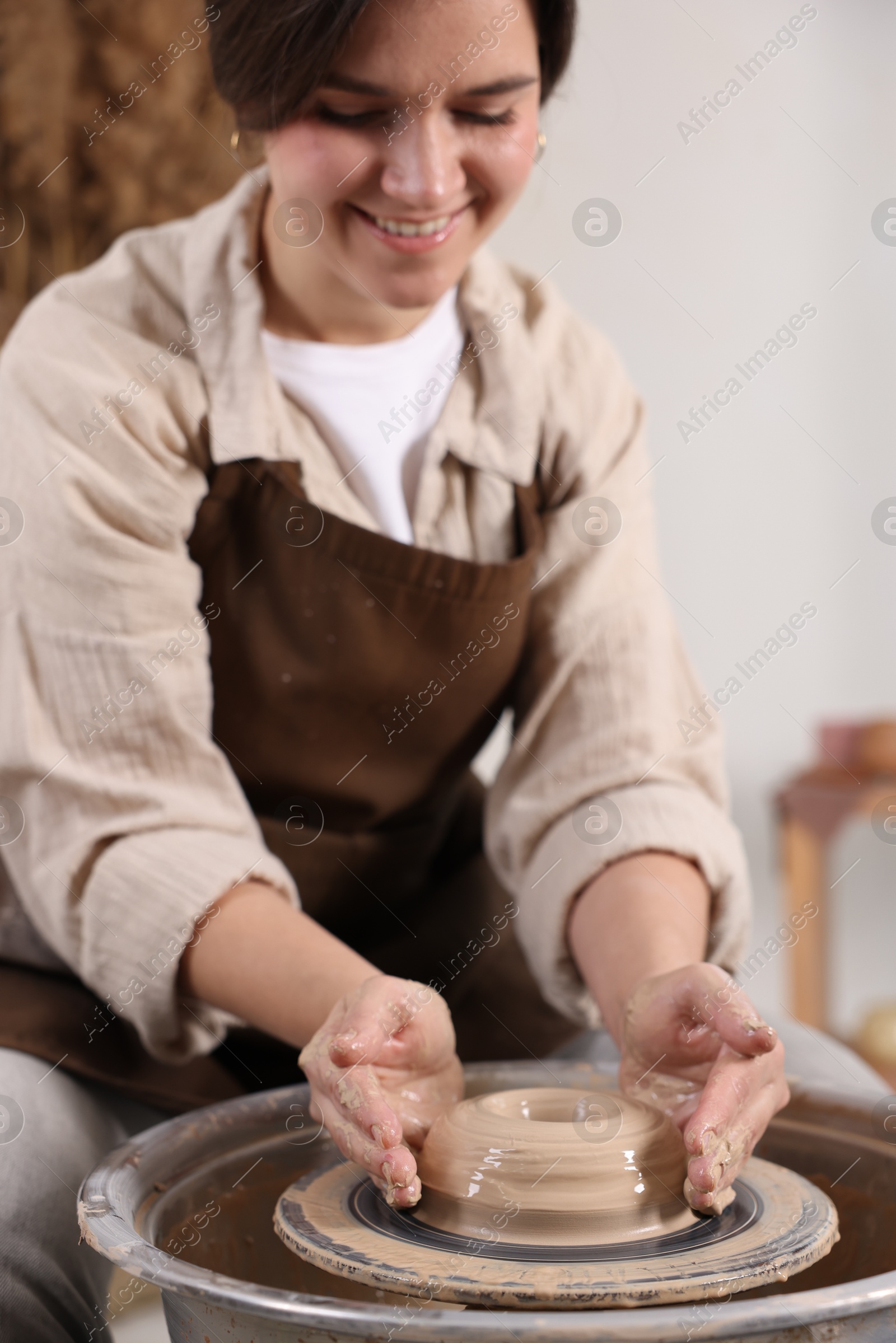 Photo of Hobby and craft. Smiling woman making pottery indoors