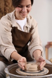 Photo of Hobby and craft. Smiling woman making pottery indoors