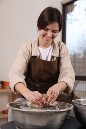 Photo of Hobby and craft. Smiling woman making pottery indoors