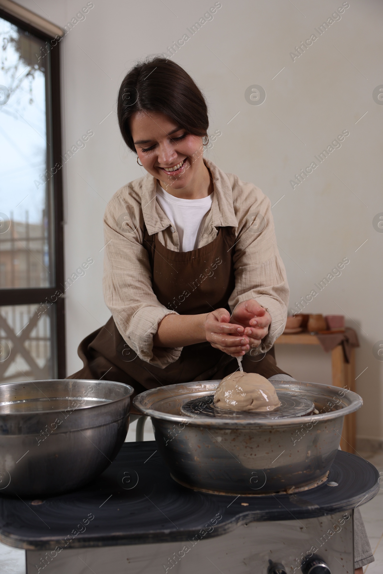 Photo of Hobby and craft. Smiling woman making pottery indoors