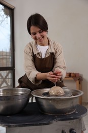 Photo of Hobby and craft. Smiling woman making pottery indoors