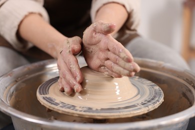 Photo of Hobby and craft. Woman making pottery indoors, closeup