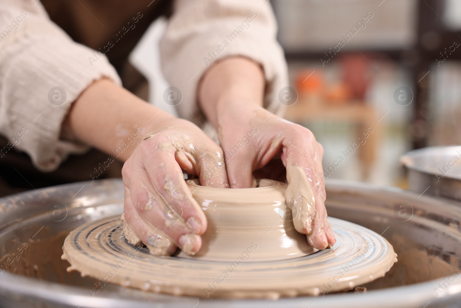 Photo of Hobby and craft. Woman making pottery indoors, closeup