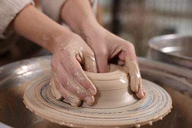 Photo of Hobby and craft. Woman making pottery indoors, closeup