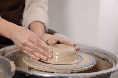 Photo of Hobby and craft. Woman making pottery indoors, closeup