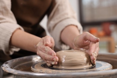 Photo of Hobby and craft. Woman making pottery indoors, closeup