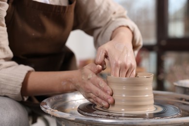 Photo of Hobby and craft. Woman making pottery indoors, closeup