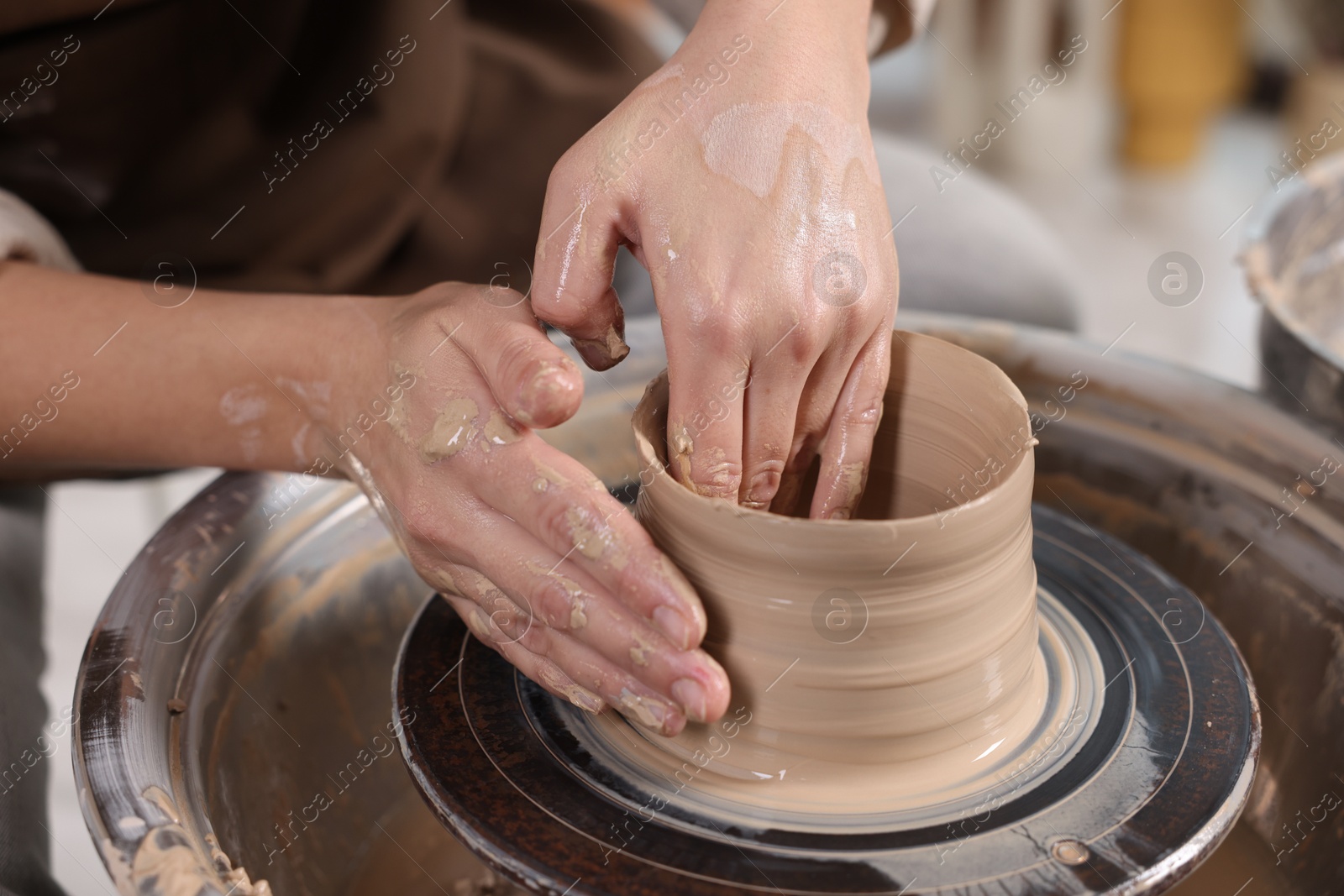 Photo of Hobby and craft. Woman making pottery indoors, closeup