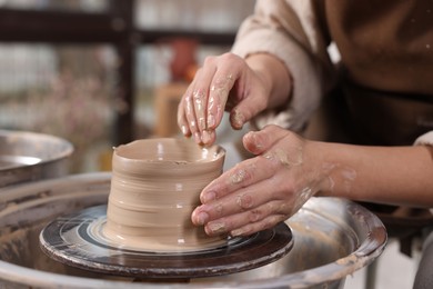 Photo of Hobby and craft. Woman making pottery indoors, closeup