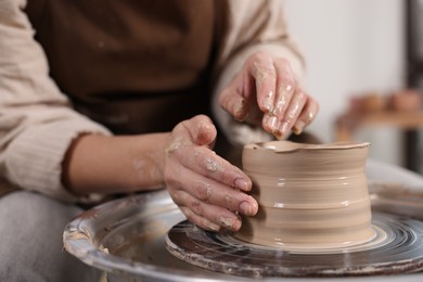 Photo of Hobby and craft. Woman making pottery indoors, closeup