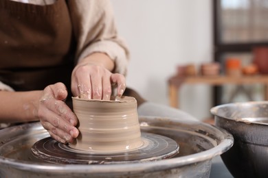 Photo of Hobby and craft. Woman making pottery indoors, closeup