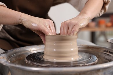 Photo of Hobby and craft. Woman making pottery indoors, closeup