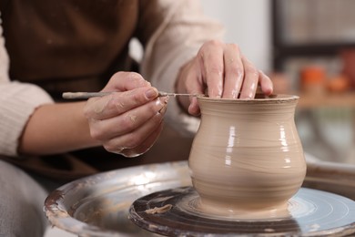 Photo of Hobby and craft. Woman making pottery indoors, closeup