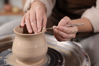 Photo of Hobby and craft. Woman making pottery indoors, closeup