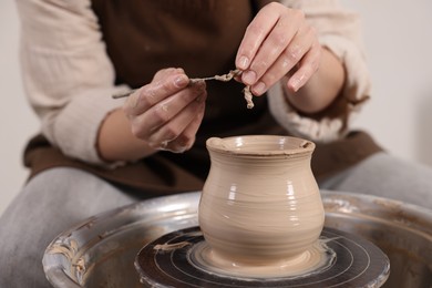 Photo of Hobby and craft. Woman making pottery indoors, closeup