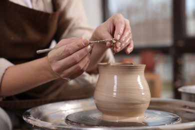 Photo of Hobby and craft. Woman making pottery indoors, closeup