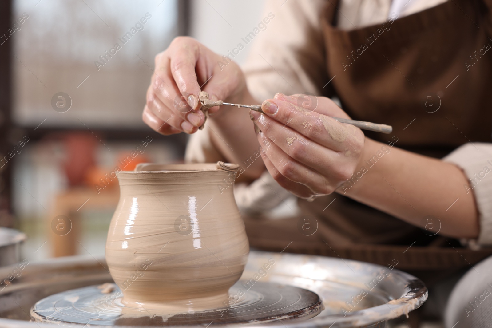 Photo of Hobby and craft. Woman making pottery indoors, closeup