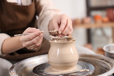 Photo of Hobby and craft. Woman making pottery indoors, closeup