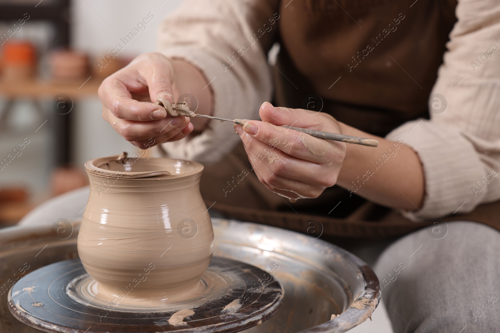 Photo of Hobby and craft. Woman making pottery indoors, closeup