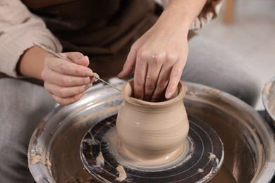 Photo of Hobby and craft. Woman making pottery indoors, closeup